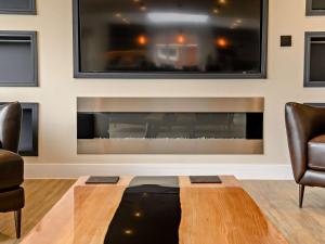 a living room with two chairs and a fireplace at 4 Bed in Weybourne 91228 in Weybourne