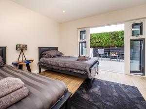 two beds in a room with a balcony at 4 Bed in Weybourne 91228 in Weybourne