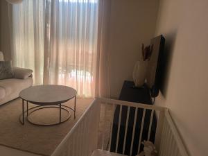 a living room with a table and a couch at LA CALA TROCADERo in Cala del Moral