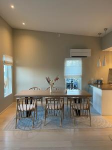 a dining room with a wooden table and chairs at Semi-detached house with lovely views of the city fjord in Askøy +4 photos
