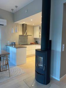 a kitchen with a stove in a living room at Semi-detached house with lovely views of the city fjord in Askøy