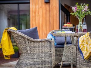 two wicker chairs and a table on a patio at 2 Bed in Longtown 79176 in Longtown