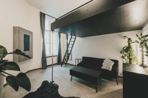 a living room with a loft bed and a couch at Altbauloft im Herzen Berlins in Berlin
