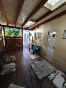 a room with a table and chairs and a door at Hogar Argentina 2 in Quilmes +9 photos