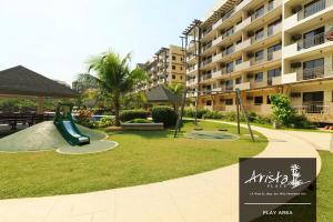 a playground in front of a apartment complex with a slide at Arista Place 2 bedroom Condo near airport in Manila