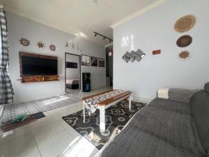 a living room with a couch and a table at D' Mande Homestay Bukittinggi in Bukittinggi