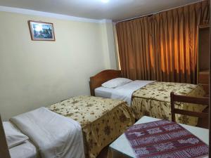 A bed or beds in a room at Hospedaje Qoricha'skas