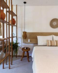 a bedroom with a bed and a wooden ladder at Almarè Refúgio, BeiraMar 30m in Pôrto de Pedras +41 photos