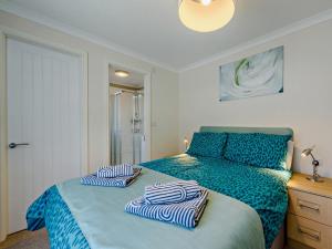 a bedroom with a bed with striped pillows on it at 2 Bed in Stepaside 91799 in Stepaside