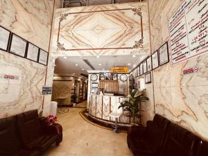 a lobby with a waiting room with leather chairs at Ghazala Beautiful Hotel shuttle service to the Haram in Mecca