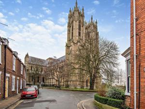 a red car parked in front of a cathedral at 2 Bed in Beverley 93219 in Beverley