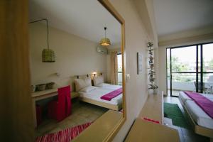 a room with two beds and a mirror at Gorgona Studios in Faliraki