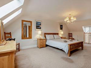 a bedroom with a bed and a dresser and a mirror at 3 Bed in Lulworth Cove DC139 in West Lulworth