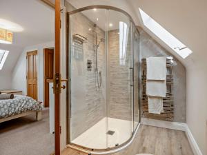 a bathroom with a glass shower in the attic at 3 Bed in Lulworth Cove DC139 in West Lulworth +34 photos
