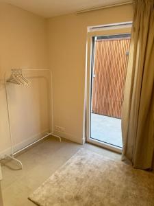 an empty room with a sliding glass door at The Salted Garden in Blankenberge