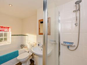 a bathroom with a toilet and a sink and a shower at 2 Bed in Arundel 89671 in Arundel +10 photos