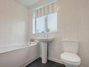 a white bathroom with a toilet and a sink at 2 Bed in Wasdale SZ077 in Santon Bridge +15 photos