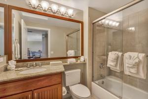 a bathroom with a toilet and a shower and a sink at Palm Villas 2 Bed/2 Bath Loft #F22 in Waikoloa +17 photos