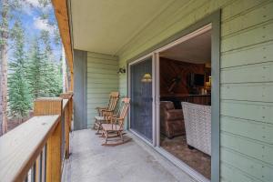 un porche con mecedoras y una puerta corredera de cristal en Powder Ridge 108 Apartment, en Breckenridge