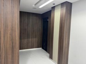 a hallway with wood paneled walls and a door at Hôtel la marina in Al Hoceïma +3 photos