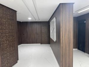 a hallway with wood paneled walls and a door at Hôtel la marina in Al Hoceïma