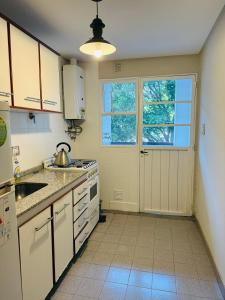 a kitchen with a sink and a stove top oven at Departamento luminoso Bulnes 3 dormitorios in San Miguel de Tucumán