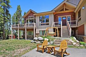 a house with two chairs and a table in front of it at Lone Hand Lodge in Breckenridge