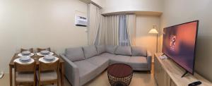a living room with a couch and a table at Amayara Nest Hospitality 2BR Condo with Netflix in Cagayan de Oro