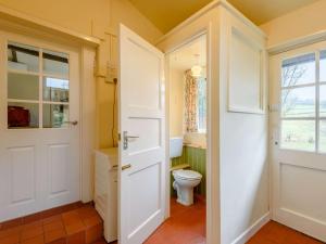 a bathroom with a white door and a toilet at 3 Bed in Builth Wells 85926 in Cregrina +36 photos