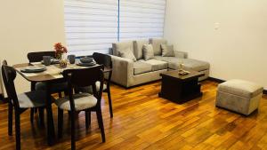 a living room with a table and a couch at Movie Escape in La Paz +22 photos