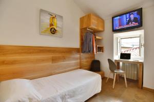 מיטה או מיטות בחדר ב-Albergo Les Dependances
