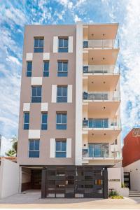 a tall apartment building with a sky in the background at Departamento a estrenar en Mburucuya in Asuncion