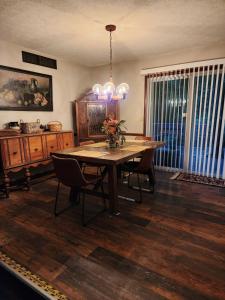 a dining room with a table and chairs and a chandelier at Urban Chalet in Douglasville