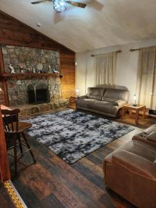 a living room with a couch and a fireplace at Urban Chalet in Douglasville