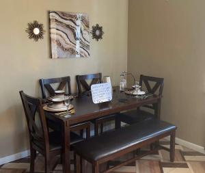 a dining room table and chairs with a sign on it at Simplicity1 in North Miami Beach