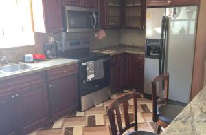 a kitchen with a refrigerator and a sink at Simplicity1 in North Miami Beach
