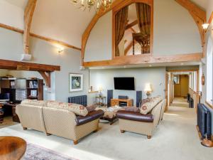 a living room with two couches and a tv at 4 Bed in Latchley 77480 in Sydenham Damerel