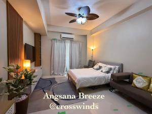 a bedroom with a bed and a ceiling fan at Angsana Breeze-Alpine Crosswinds Tagaytay in Ulot