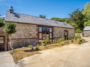 a stone house with a garden in front of it at 4 Bed in Cowes 88913 in Porchfield