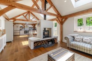 a living room with a couch and a fireplace at Stable Cottage in Ringwood