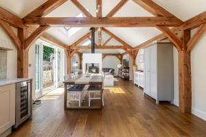 a kitchen with wooden ceilings and a table and chairs at Stable Cottage in Ringwood +25 photos