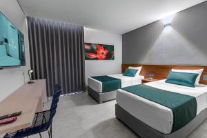Postel nebo postele na pokoji v ubytování HOTEL RILUX Barrancabermeja