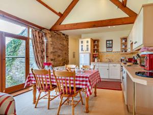 a kitchen with a table with a red and white table cloth at 2 Bed in Bassenthwaite 93463 in Ireby