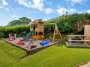 a play set with a playground and a swing at 1 Bed in Brecon BN015 in Brecon