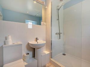 a white bathroom with a sink and a shower at 3 Bed in Shaftesbury 95685 in Sedghill +8 photos