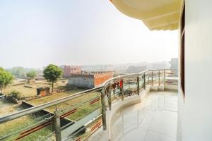 a balcony with a view of a city at Hotel O Arpit Hotel Jhusi Railway Station in Jhūsi