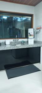 a kitchen counter with a sink and a window at Suite das Belas Vistas Lumiar - De tirar o fôlego! in Lumiar