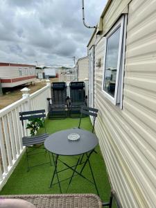 a patio with two chairs and a table on a balcony at Avas Special Place in Ingoldmells