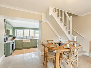 a kitchen and dining room with a table and chairs at 2 Bed in Burton Bradstock 93076 in Burton Bradstock +7 photos
