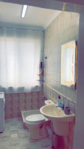 a bathroom with a toilet and a sink at شقق رتيل in Amman